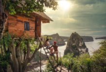 Your ultimate guide to Nusa Penida in Bali couple sitting on brown wooden ladder