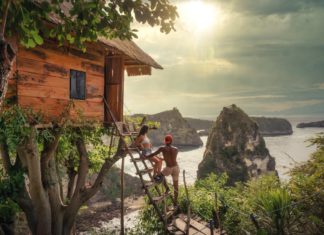 Your ultimate guide to Nusa Penida in Bali couple sitting on brown wooden ladder