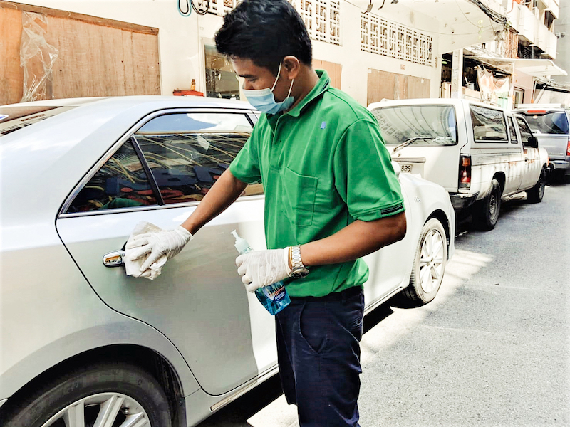 TripGuru tour guide disinfecting a car before a tour